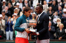 Rafael Nadal receives the trophy from Usain Bolt