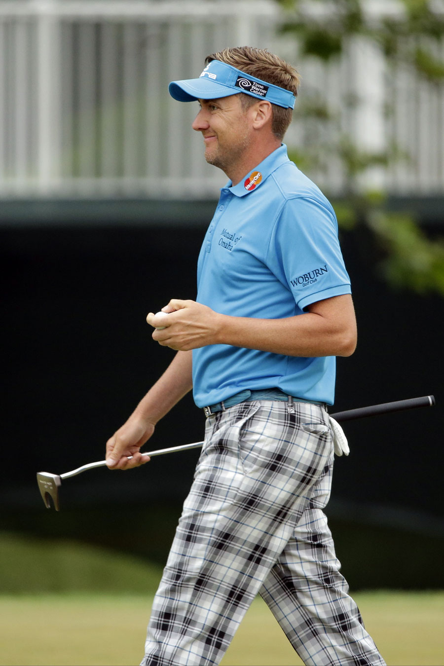 Ian Poulter walks with a grin on his face