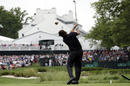 Phil Mickelson hits a shot to the par-three 13th