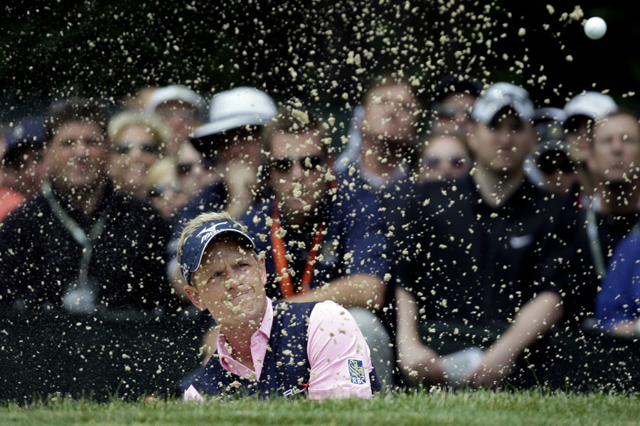 Luke Donald splashes out of a bunker