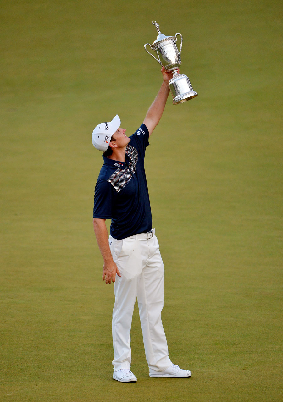 Justin Rose lifts the US Open trophy in the air
