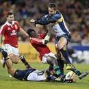 Brumbies Matt Toomua and Andrew Smith tackle the Lions' Christian Wade