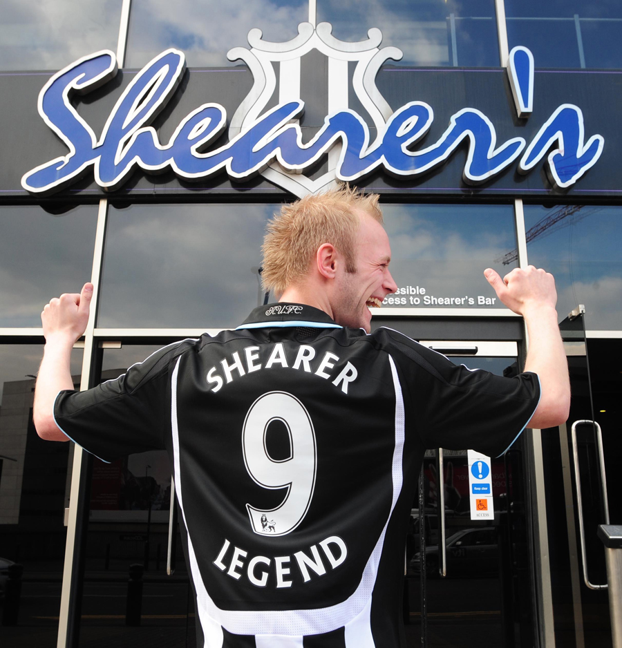 A fan poses outside Shearer's bar