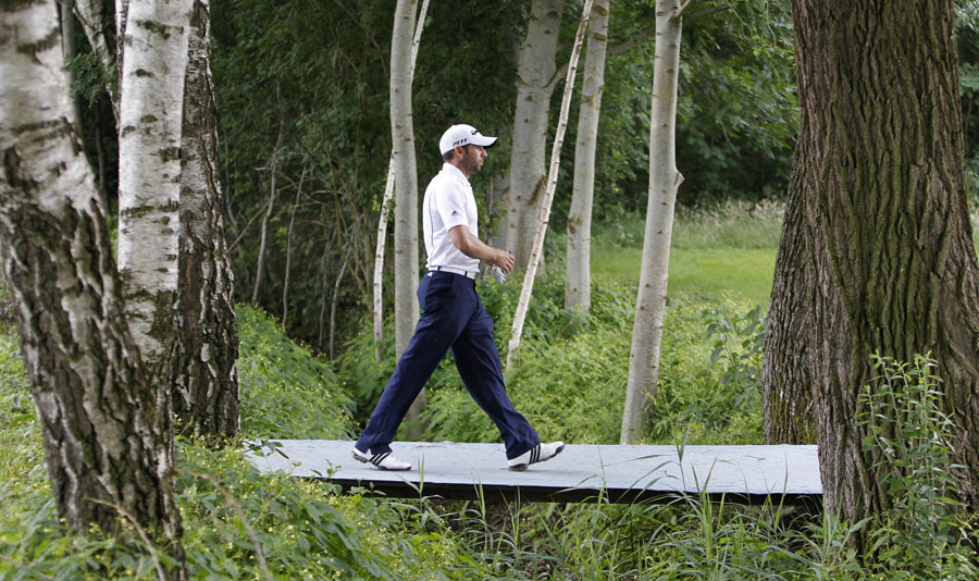 Sergio Garcia walks next to trees