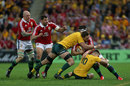 George North is tackled by Kane Douglas and James O'Connor 