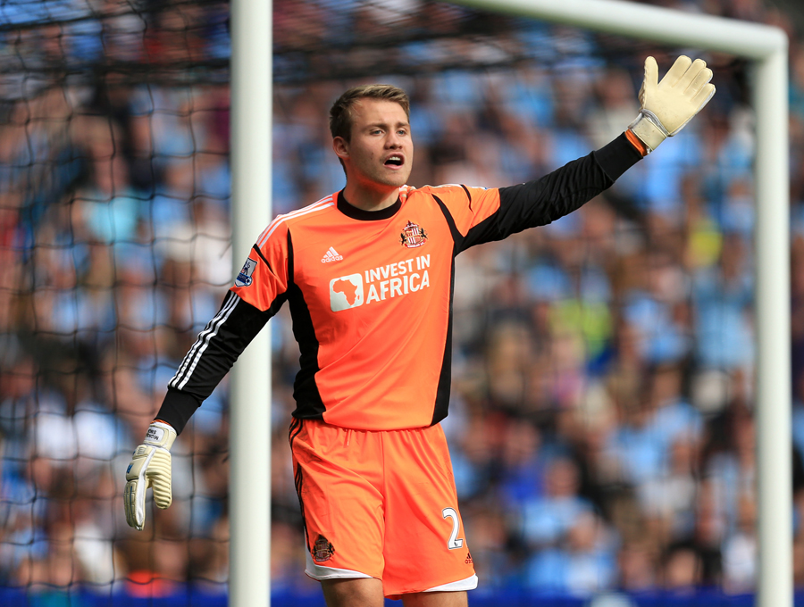Simon Mignolet gestures to his defence
