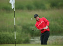 Rory McIlroy plays a chip