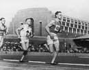 Jim Alford rounds the bend in third on his way to victory in the mile at the British Empire Games