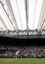 Novak Djokovic serves under the Centre Court roof
