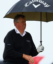 Colin Montgomerie shelters from the rain 