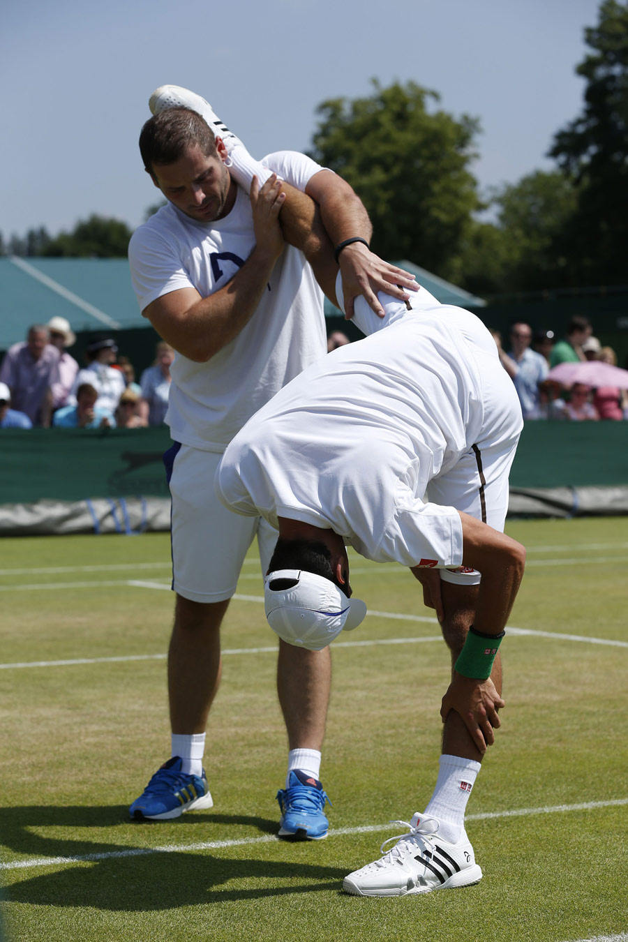 Novak Djokovic stretches out in training