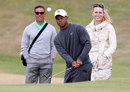 Tiger Woods hits a chip shot as Sean Foley and Lindsey Vonn watch on