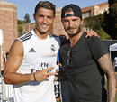 Cristiano Ronaldo and David Beckham pose for a photographer