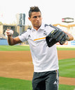 Cristiano Ronaldo attempts to throw a baseball