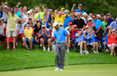 Tiger Woods makes a birdie putt on the 12th green