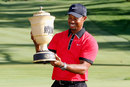 Tiger Woods holds up the Gary Player Cup