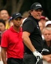 Phil Mickelson is watched by Tiger Woods