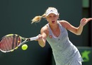 Caroline Wozniacki returns a shot against Justine Henin