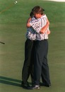 Greg Norman is hugged by Nick Faldo