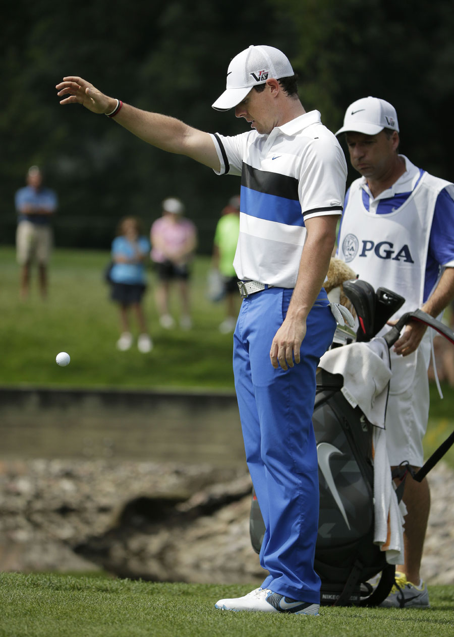 Rory McIlroy takes a drop after finding water