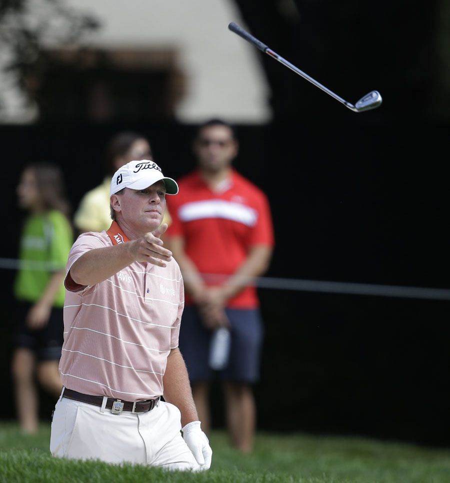 Steve Stricker tosses his club after hitting out of a bunker 