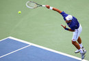 Novak Djokovic climbs high for a serve