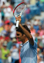 Roger Federer raises his racket