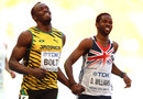 Usain Bolt shares a laugh with Delano Williams after their 200-metre heat
