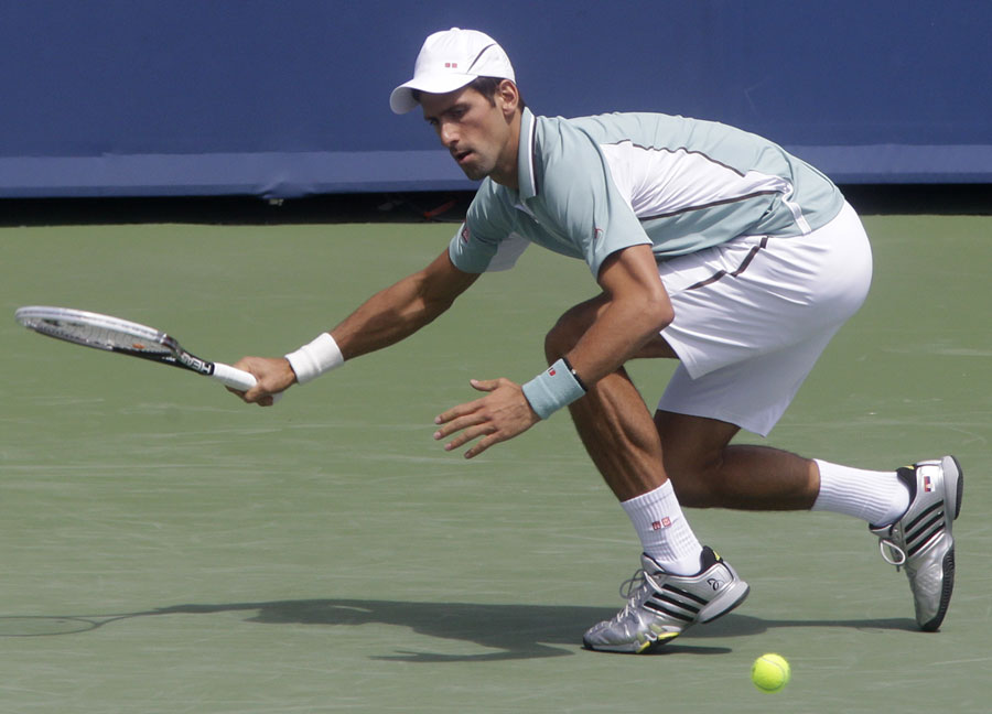 Novak Djokovic goes low for a ball