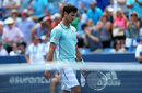 Novak Djokovic walks off dejected after losing to John Isner