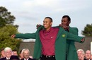 Tiger Woods is presented with his green jacket by Vijay Singh