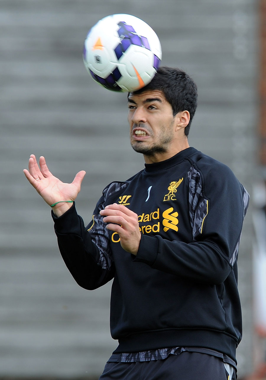 Luis Suarez keeps his eyes on the ball in training