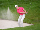 Tommy Fleetwood plays out of the bunker during his third round