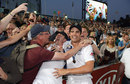 Kevin Pietersen and Alastair Cook are mobbed by the fans