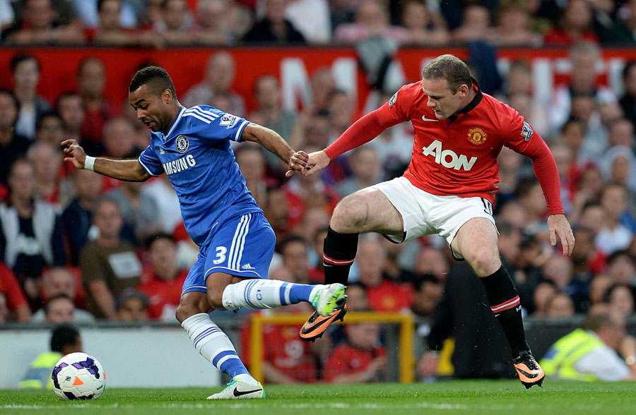 Ashley Cole and Wayne Rooney fight for the ball