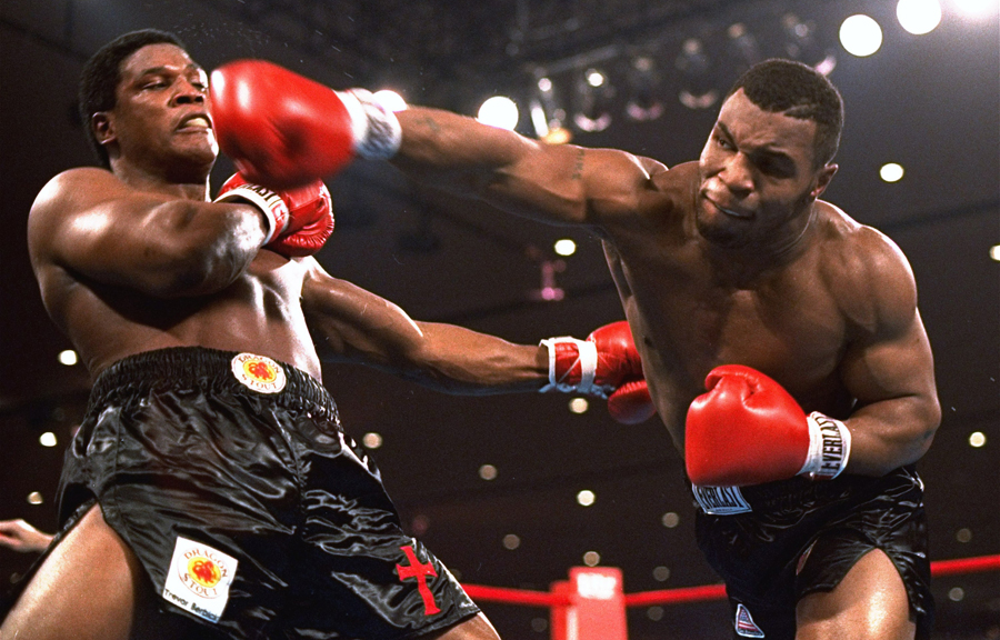 Mike Tyson throws a punch at Trevor Berbick