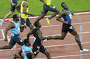Usain Bolt looks on with a smile on his face