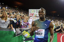 Usain Bolt points to the camera in celebration