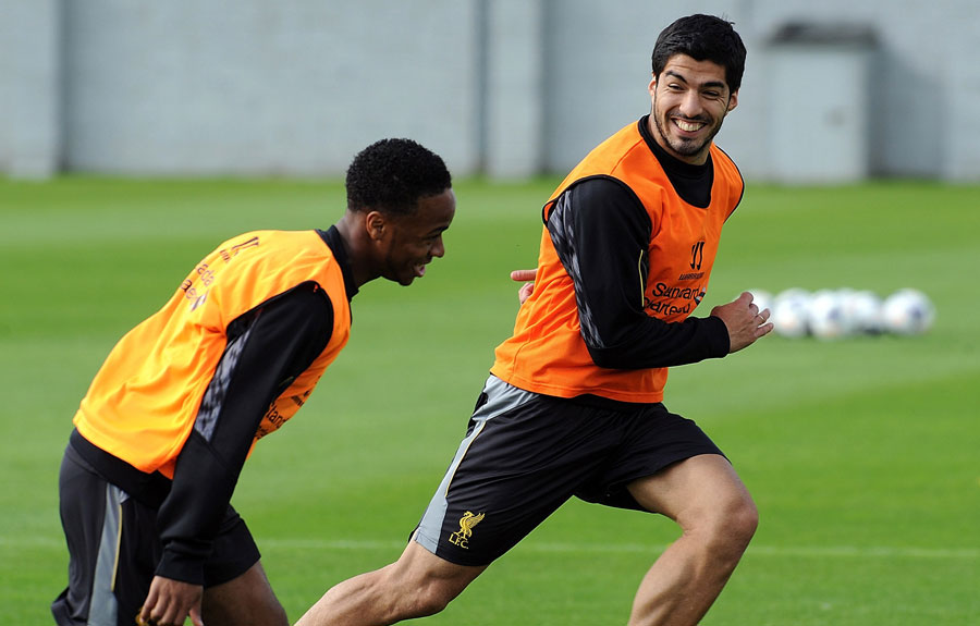 Luis Suarez shares a joke with Raheem Sterling in Liverpool training