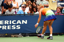 Svetlana Kuznetsova attempts to remove a squirrel from the court
