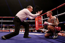 Ricky Burns is counted by the referee following his knock down in the eighth round