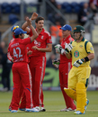 Steven Finn is mobbed by team-mates after dismissing Aaron Finch