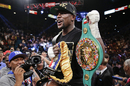 Floyd Mayweather Jr holds up his title belts after defeating Canelo Alvarez during a 152-pound title fight