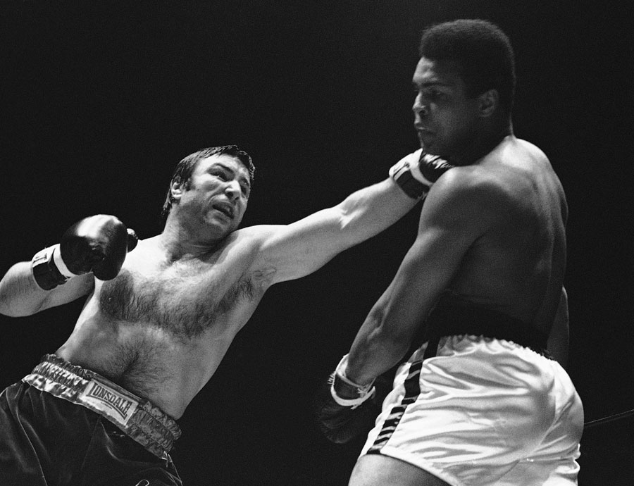George Chuvalo connects with a left to the head of Muhammad Ali