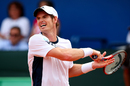 Andy Murray grimaces as he forces a return against Ivan Dodig