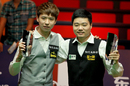 Xiao Guodong and winner Ding Junhui stand with their trophies