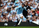 Carlos Tevez evades a tackle from James McFadden