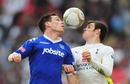 Steve Finnan and Gareth Bale keep their eyes on the ball