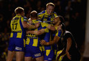 Simon Grix is mobbed by his team-mates after scoring the winning try
