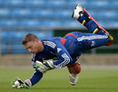 Jos Buttler dives during a training session